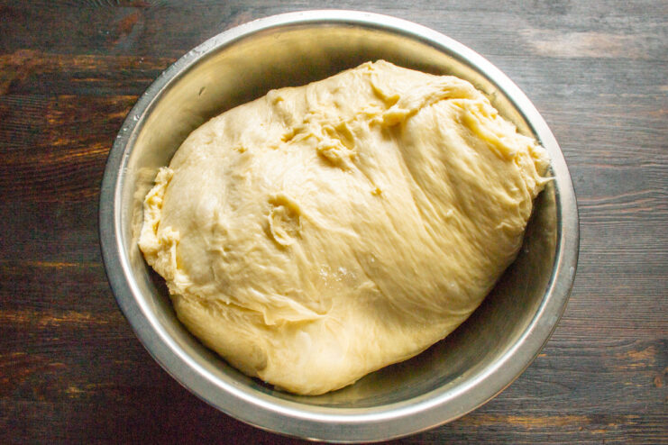 Combining Wet and Dry Ingredients to Form the Dough A spatula mixing flour and liquid ingredients in a bowl to form a dough.