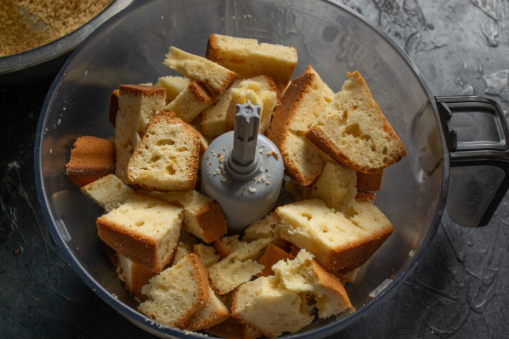 Making sponge cake crumbs in a food processor Cubes of cooled sponge cake being turned into crumbs inside a food processor.