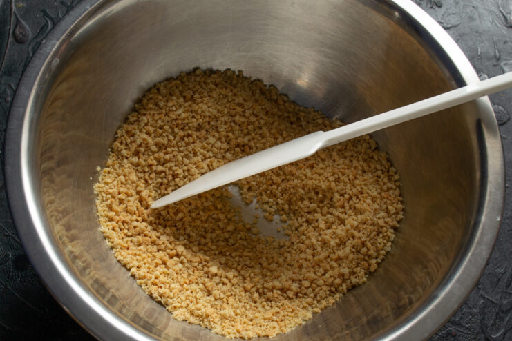 Grinding roasted peanuts in a blender Roasted peanuts being ground into fine crumbs in a blender.