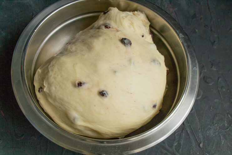 Step 7: Kneading the dough until smooth and elastic. A person kneading the soft, smooth dough on a lightly floured surface.
