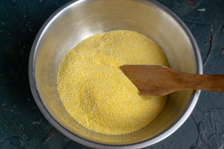 Measuring Fine Cornmeal for Polenta A bowl of fine yellow cornmeal (polenta) being measured for the recipe.