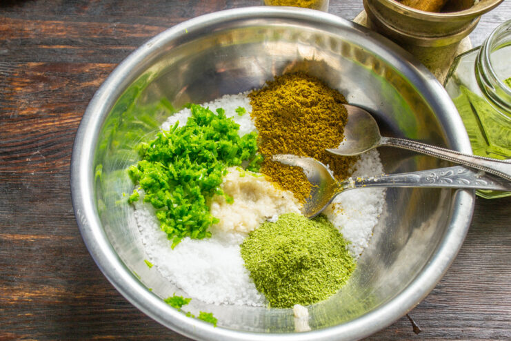 Incorporating Khmeli-Suneli for a Georgian Flavor Profile A spoonful of khmeli-suneli spice blend being added to the salt mixture.