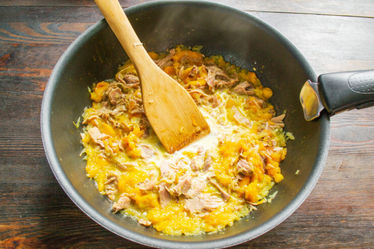 Creating the Creamy Thickener for the Stew A small bowl with cream and rice flour being mixed with a spoon to create a slurry.