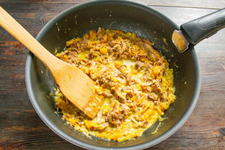 Finishing the Stew with Cream The finished pumpkin and turkey stew simmering in a skillet after adding the cream.