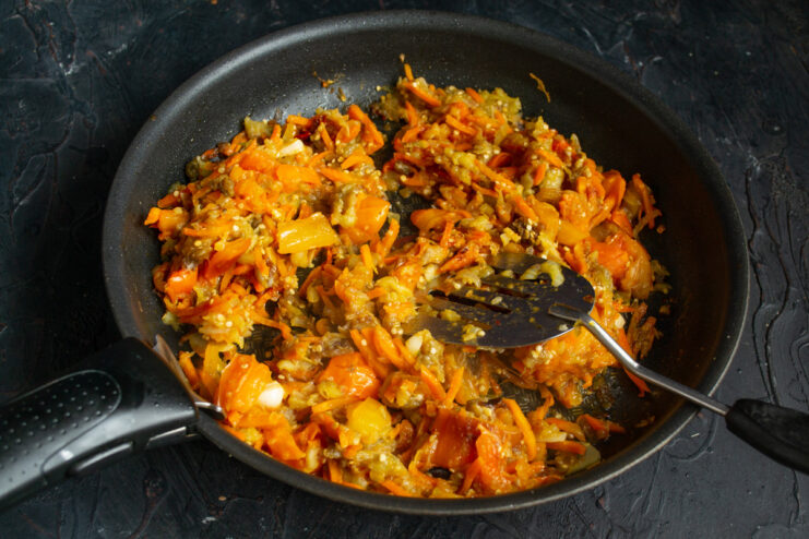 Simmering the Ragout to Reduce Liquid and Concentrate Flavors Vegetable ragout simmering vigorously in a skillet to reduce.