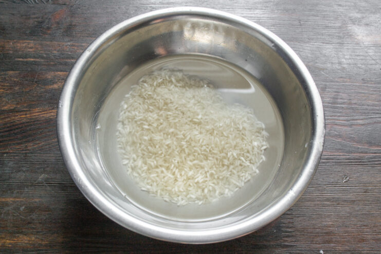 How to Cook Perfect Fluffy Rice for Your Dish White rice cooking in a pot of water.