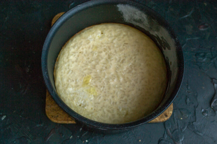 Step 7: Baking the rice casserole until golden and set. The baking dish with the casserole batter placed on a rack inside an oven.