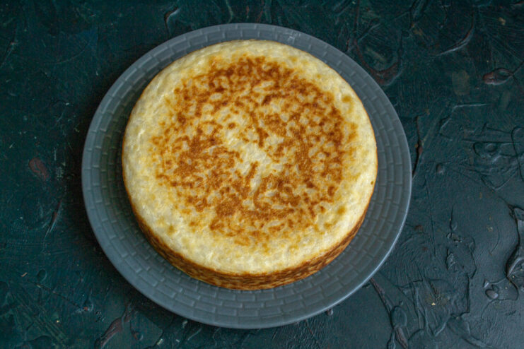 Serving suggestion: Enjoy the warm rice casserole with your favorite sweet toppings. A slice of the finished rice and ricotta casserole on a plate, served with jam.