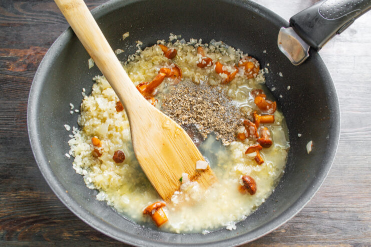Deglazing the Pan with White Wine for Risotto Pouring white wine and chicken broth into the skillet with toasted rice and mushrooms.
