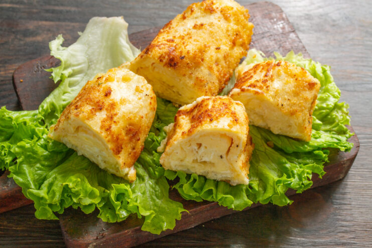 The finished 3 Cheese Lavash Roll, ready to be served A perfectly fried golden-brown 3 Cheese Lavash Roll on a plate, ready to be served hot.
