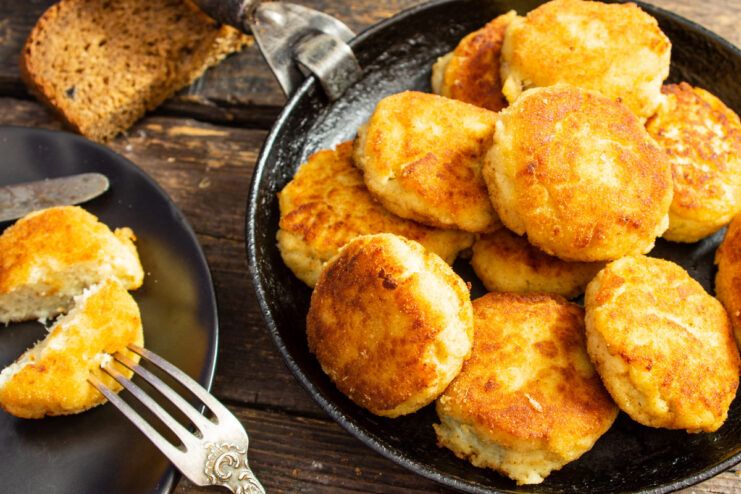 A plate of golden-brown fish and potato patties, ready to be served.