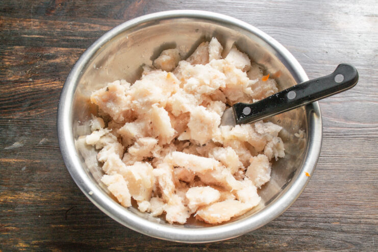 Thawed pollock mince in a bowl, ready for the fish patty recipe. A clear bowl containing thawed minced pollock fish.