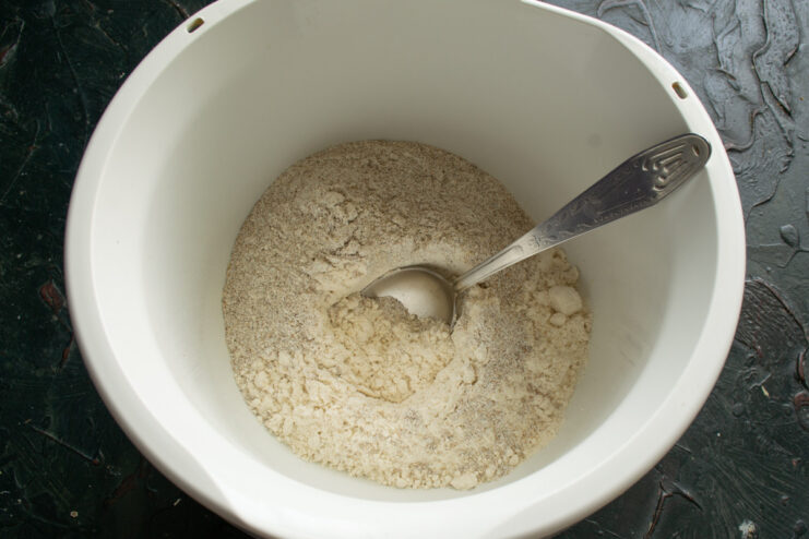 Mixing Wheat and Rye Flour for the Dough A bowl containing a mix of wheat and rye flour for the sourdough bread recipe.