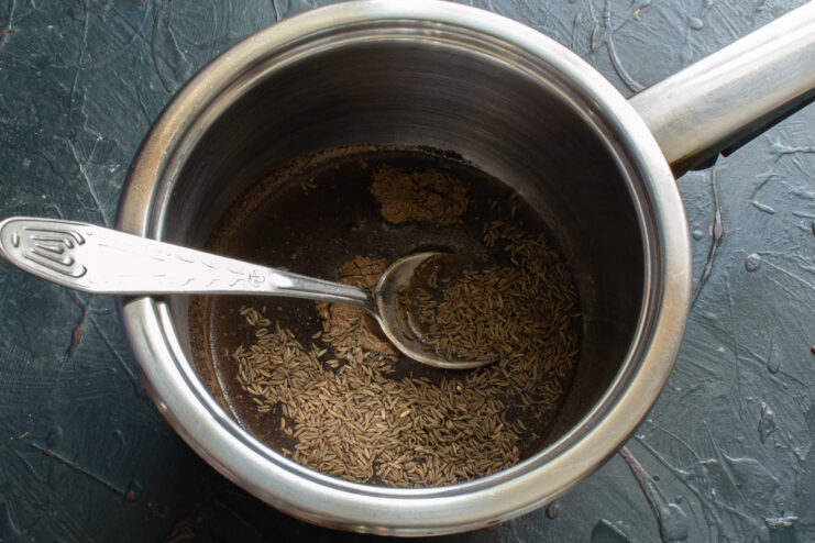 Preparing the Liquid Ingredients in a Saucepan A saucepan with water or whey, the first step for preparing the liquid base for rye bread.