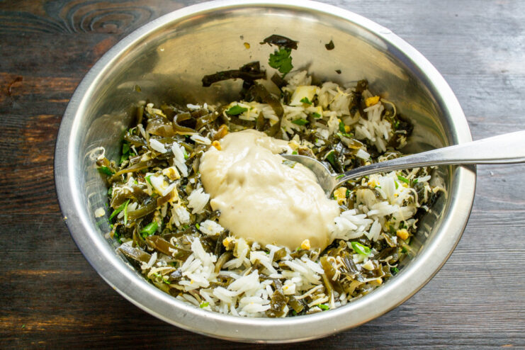 Whipping up a creamy homemade dressing Preparing the homemade dressing in a small bowl with an egg yolk and mustard.