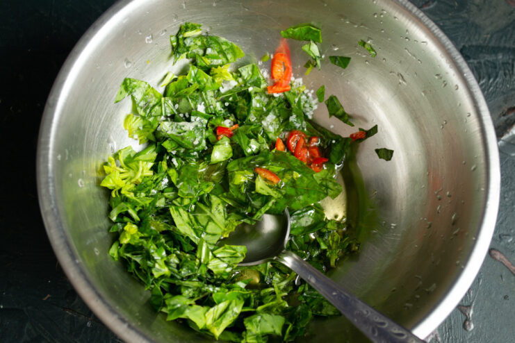 Preparing the Vinaigrette Dressing Ingredients for the salad dressing in a small bowl: olive oil, mustard, and herbs.