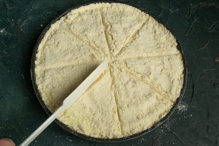 Adding the Top Crumble Layer Sprinkling the remaining crumble mixture over the cottage cheese filling to create the top crust.