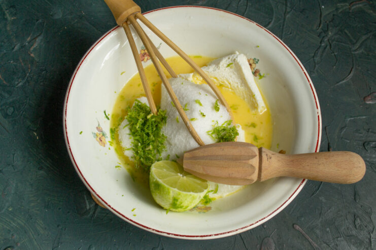 Adding Citrus Zest and Juice for Flavor Grating lime zest into a bowl with the cottage cheese mixture.