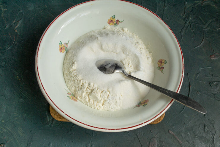 Preparing the Dry Ingredients for the Crust A bowl containing the dry ingredients for the pie crust: flour, sugar, and baking powder.