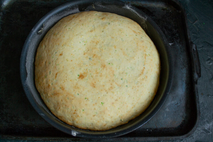 Bake the zucchini pie until golden brown and a skewer inserted into the center comes out clean. The baking dish with the zucchini pie batter going into a preheated oven.