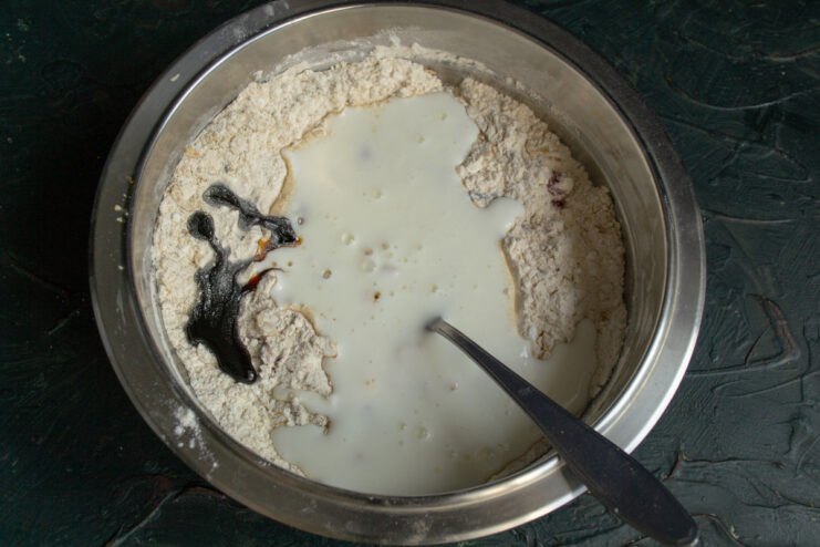Step 5: Adding wet ingredients - kefir and rye malt syrup. Pouring kefir and rye malt syrup into the bowl with the dry ingredients.