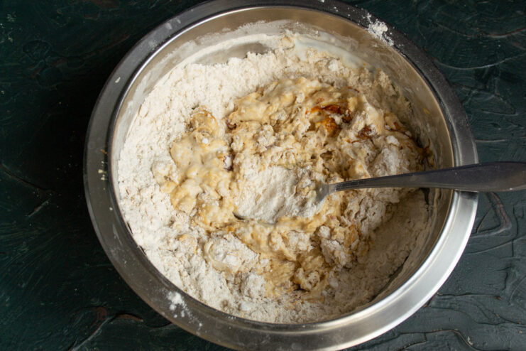 Step 6: Mixing the dough until just combined - it will be sticky. Mixing the sticky soda bread dough in a bowl with a spoon.