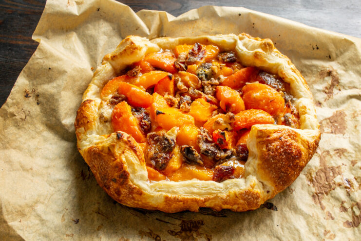 Baking the pie until the crust is golden brown and flaky. The apricot and date puff pastry pie baking in the oven.
