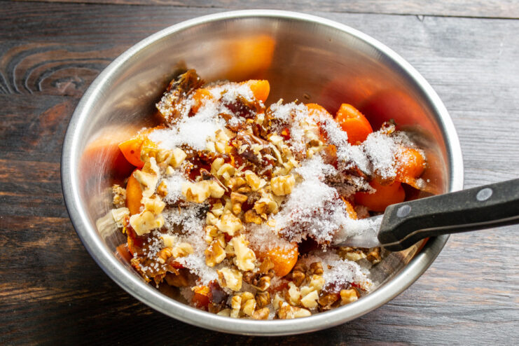 How to crush walnuts for a crunchy pie filling. A bowl of coarsely chopped walnuts ready to be added to the filling.