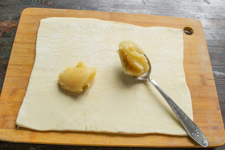 Spreading honey over the bottom sheet of puff pastry for the pie.