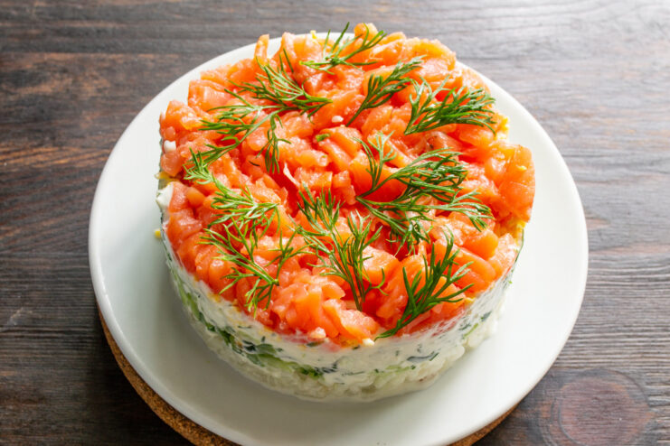 The Finished Layered Salad, Ready to Serve The finished layered salad with red fish, topped with diced trout and garnished with fresh dill.