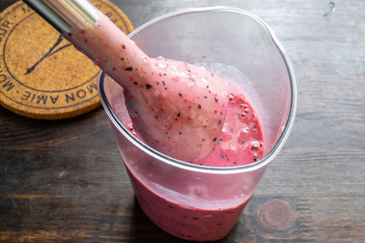 Step 5: Sweetening the Smoothie to Your Liking Adding a spoonful of sugar to the blender cup with other smoothie ingredients.
