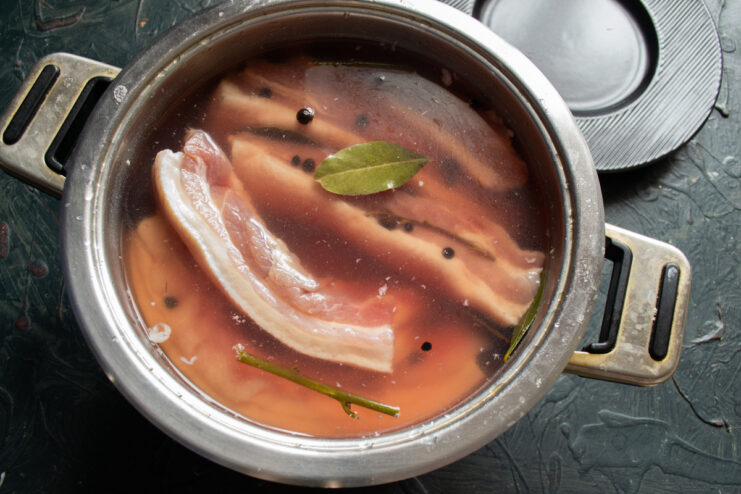 Step 7: Refrigerating the Pork for 72 Hours A container with pork belly in brine, covered and ready to be placed in the refrigerator for curing.