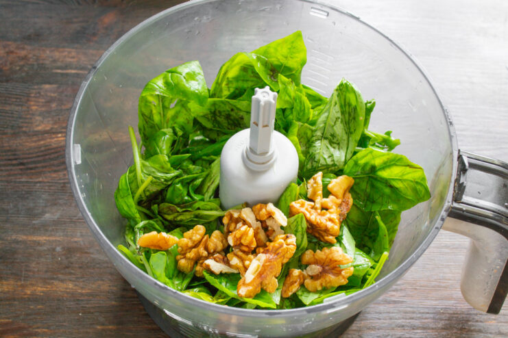 Toasting walnuts to enhance the flavor of the pesto Walnuts being toasted in a dry skillet to bring out their flavor.