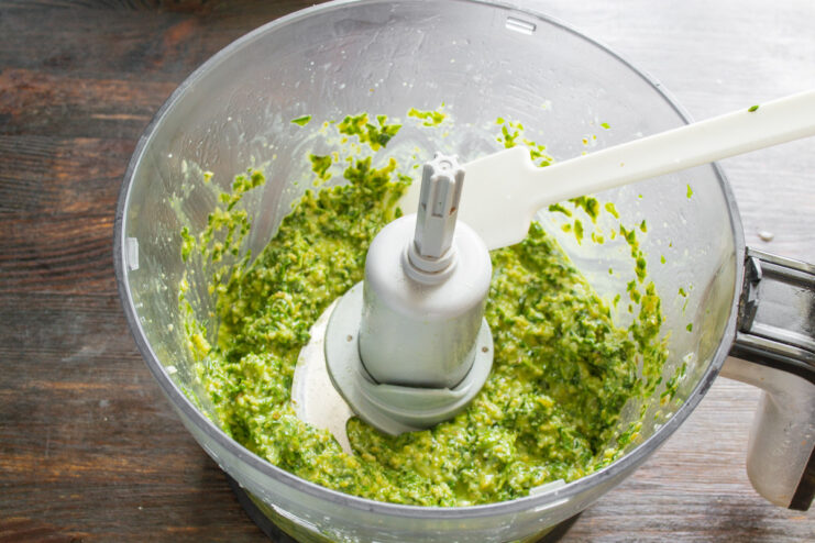 Blending all ingredients until the pesto is smooth Blending the pesto ingredients in a food processor until a smooth paste forms.