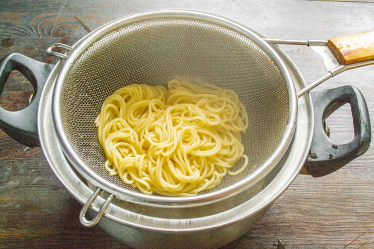Cooking spaghetti al dente for the recipe Spaghetti pasta cooking in a pot of boiling water.