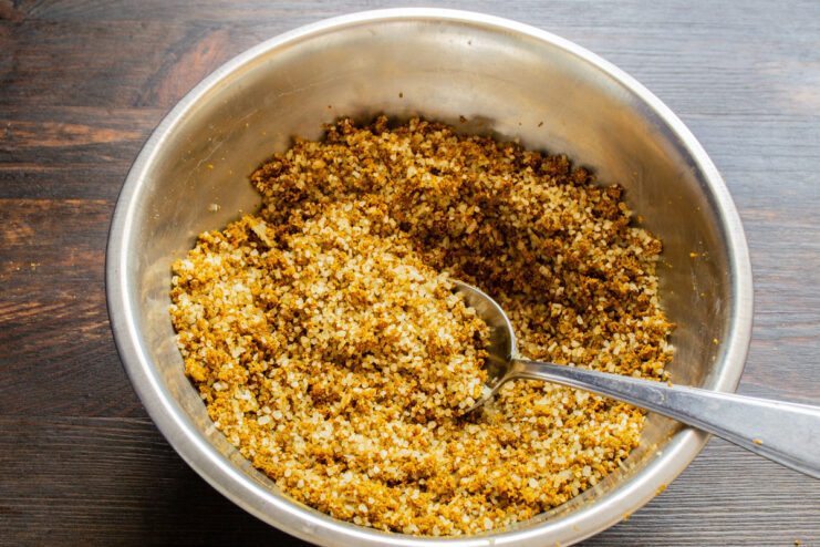Hand-Mixing the Svanetian Salt for Perfect Consistency Hands in gloves thoroughly mixing garlic paste into the salt and spice blend.