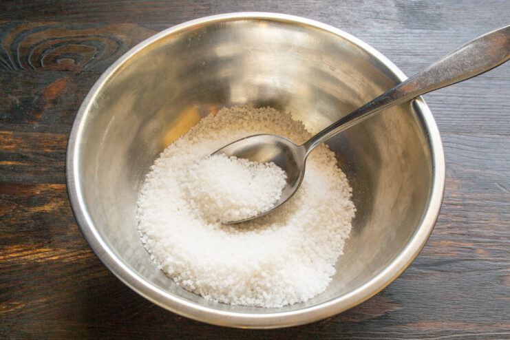 Step 1: Starting with a Base of Coarse Sea Salt A wide white bowl filled with coarse sea salt, the first step in making Svanetian salt.