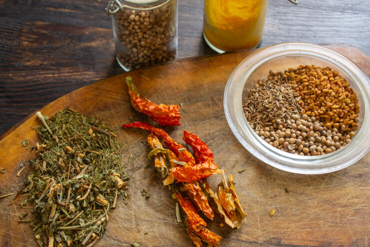 Assembling the Spices for Svanetian Salt Various spices like chili peppers, coriander, and fenugreek seeds laid out for the recipe.