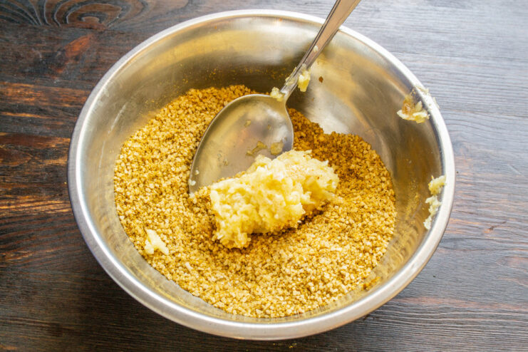 Adding Fresh Garlic Paste to the Salt Mixture Mashed garlic paste being added to the bowl of salt and spice mixture.