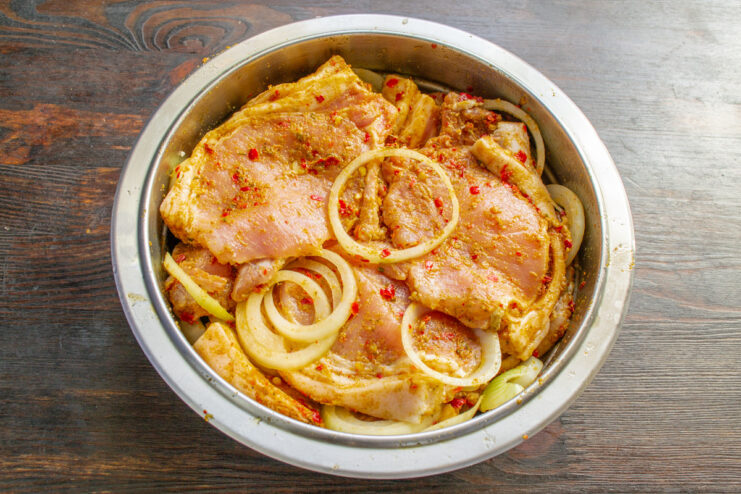 Step 5: Mixing Pork with Onions for Marination Pork loin and onions mixed together in a bowl, marinating.