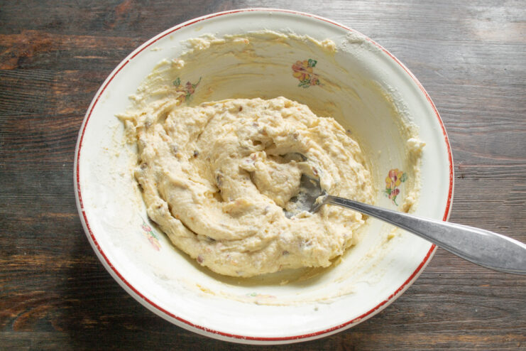 Resting the Syrniki Dough Before Frying Well-mixed syrniki dough with ricotta and dates resting in a white bowl.