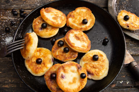 Syrniki — Farmer’s Cheese Pancakes with Rolled Oats and Black Currants