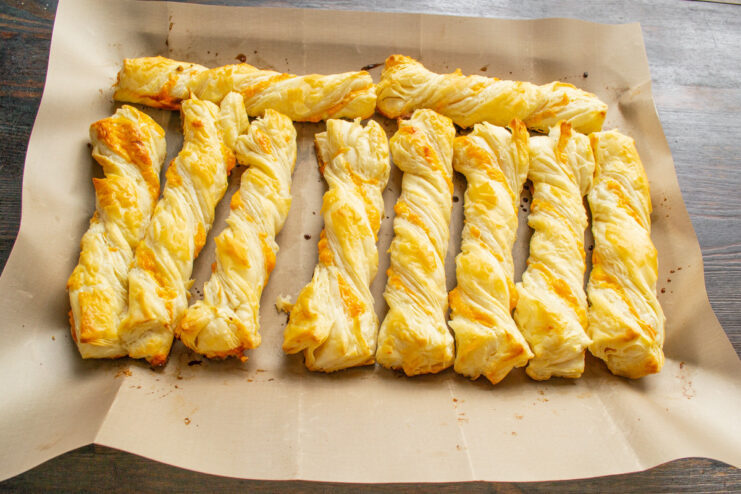 Baking the Cheese Sticks to Golden Perfection A baking sheet with uncooked cheese sticks ready to be placed into an oven.