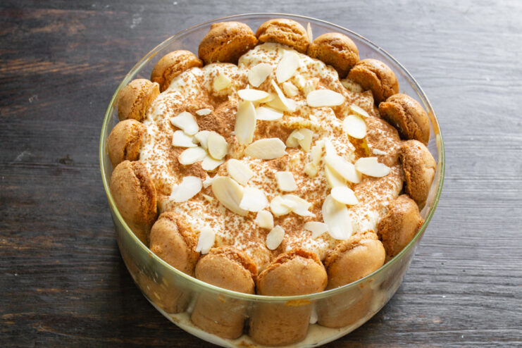 The finished Tiramisu, generously dusted with cocoa powder and topped with almond flakes.