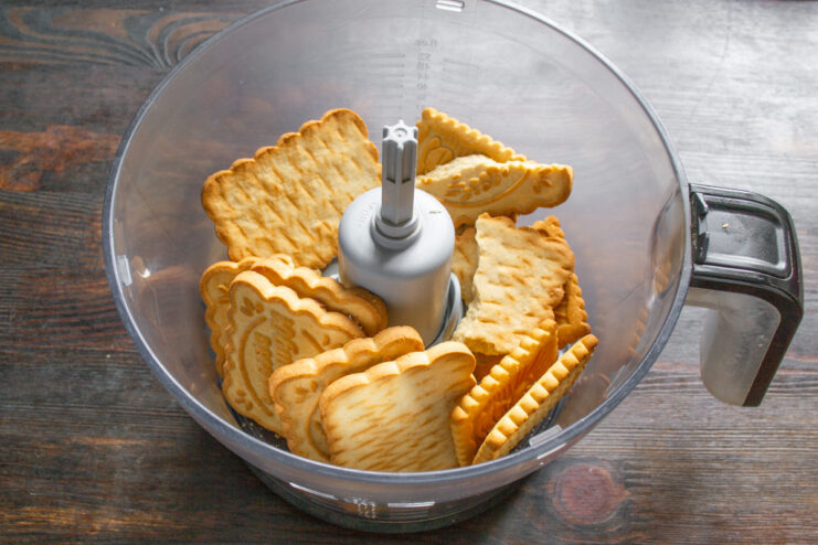 Step 1: Crushing Cookies for the Cake Crust Shortbread cookies inside a blender bowl, ready to be crushed to make the base for a no-bake cake.