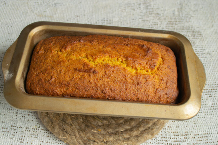 Baking the Tvorog and Pumpkin Loaf Cake A loaf pan with cake batter placed on the middle rack inside a preheated oven.