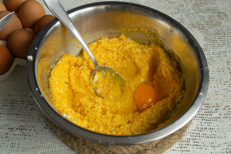 Mixing in Eggs and Lemon Juice for the Cake Batter A bowl containing the cake batter with eggs and lemon juice being mixed in.