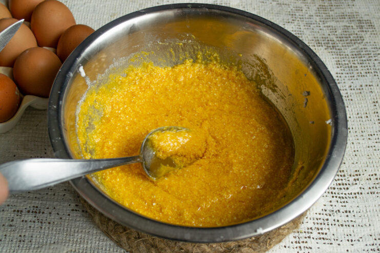 Adding Oil to the Pumpkin Cake Batter Pouring vegetable oil from a bottle into the bowl with the cake batter.