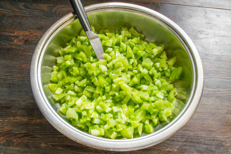 Choosing the Right Pot for Making Jam Chopped green tomatoes in a large, thick-bottomed sauté pan.