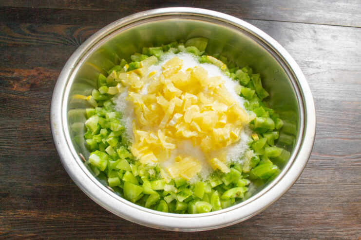 Preparing the Lemon for the Jam A whole lemon and finely chopped lemon with zest ready to be added to the jam.
